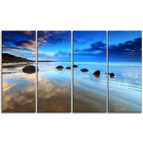 Design Art 'Cloudy Sky Over Moeraki Boulders' Photographic Print on Wrapped Canvas - Size: 16 inch H x 32 inch W x 1 inch D, Blue
